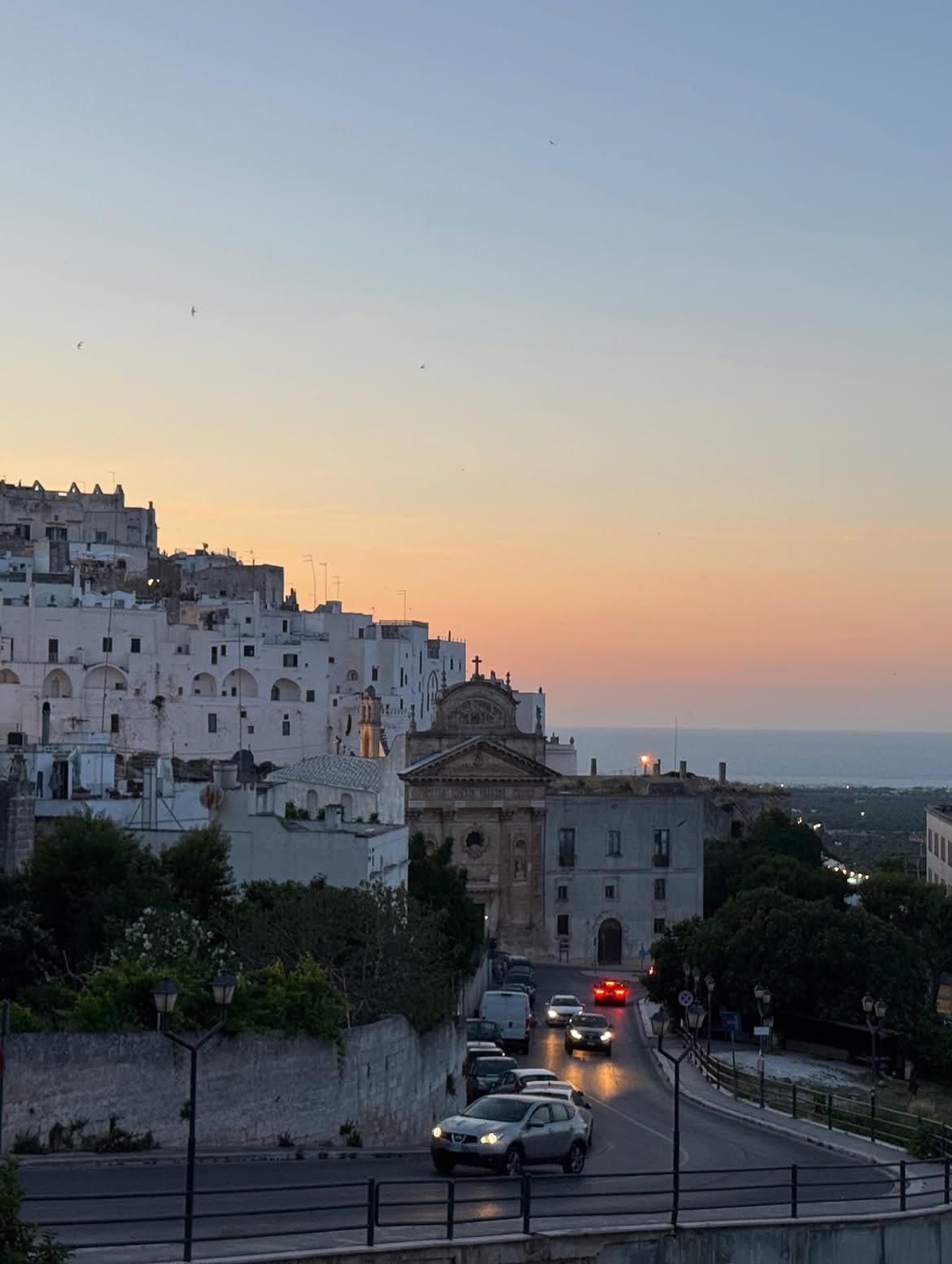 evening light over Locorotondo or Ostuni with whitewashed houses and warm sky